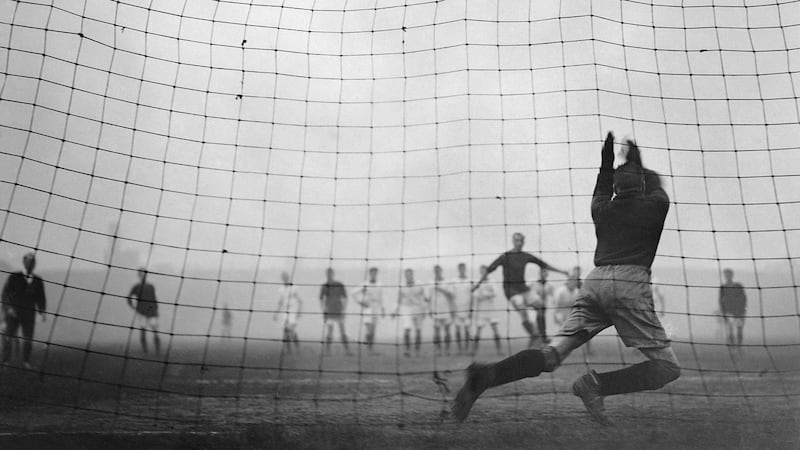 Elisha Scott saves a penalty during an FA Cup match against Arsenal in 1923. The legendary Irish goalkeeper made his debut in 1912 and left the club 22 years late. Photograph: Topical Press Agency/Getty Images)