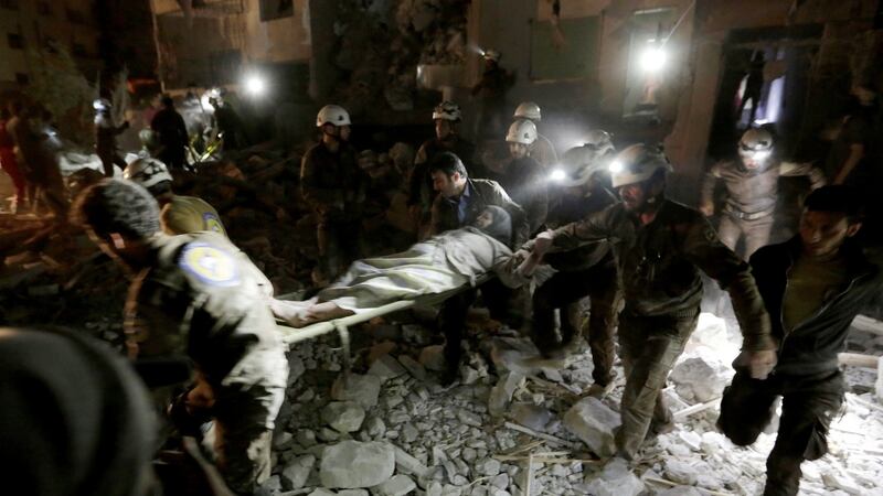 An injured woman on a stretcher at a site damaged after Russian air strikes on Idlib, Syria. Photograph: Khalil Ashawi/Reuters
