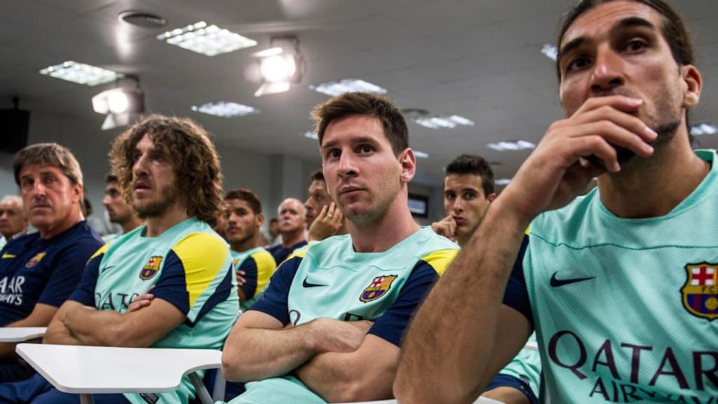 Barcelona players, including Carles Puyol, second left, and Lionel Messi, centre, attend a press conference at the Sports Center FC Barcelona Joan Gamper in San Joan Despi, Spain yesterday to announce coach Tito Vilanova was stepping down because of a recurrence of a throat illness. Photograph: David Ramos/Getty Images)