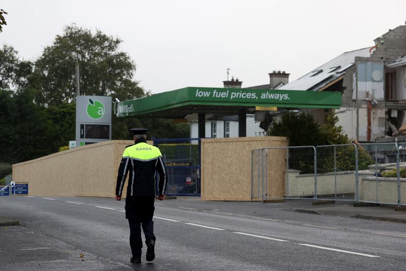 In a photograph taken shortly after the explosion, a Garda walks towards the scene in the village of Creeslough in Co Donegal. Photograph: Liam McBurney