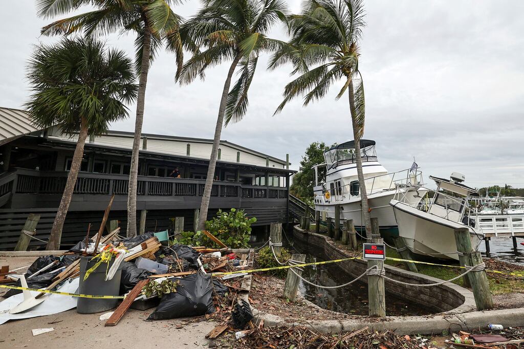 Hurricane Helene: boats rest beside a restaurant after being pushed up by floodwaters from the storm in St Petersburg, Florida. Photograph: Mike Carlson/AP