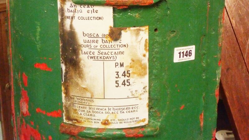 The embossed royal cypher is clearly visible through the green paint.