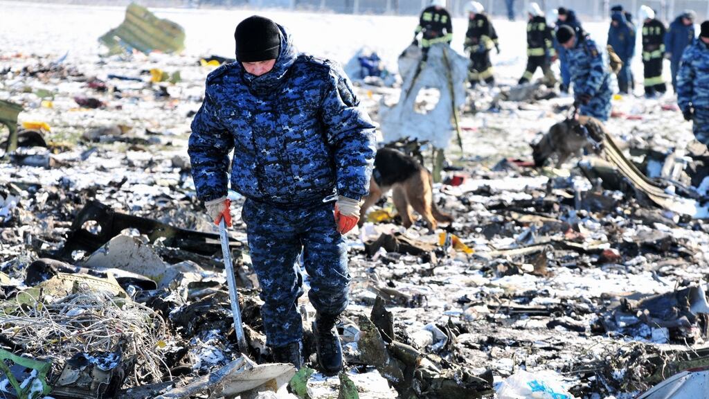 Russian investigators and police inspect the crash site of a Boeing 737-800 plane of Flydubai at the airport of Rostov-on-Don, Russia, on Sunday. Photograph: Arkady Budnitsky/EPA