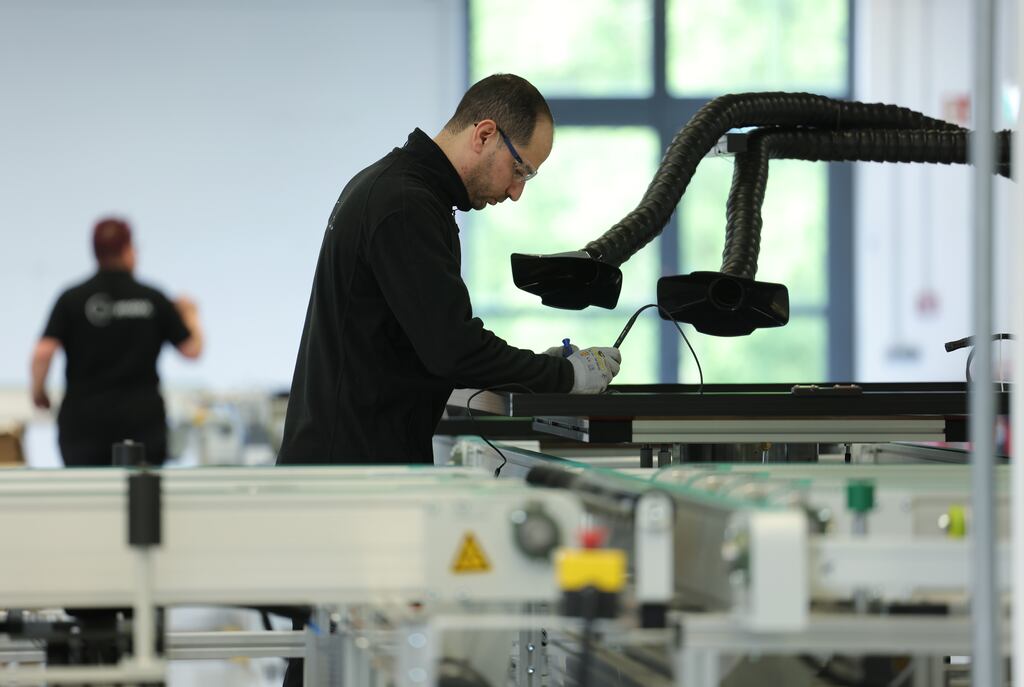 A worker assembles a photovoltaic thermal collector on  production line at Sunmaxx in Ottendorf-Okrilla  Dresden, Germany.  Business activity in the eurozone has expanded at the fastest pace for almost a year, indicating the region’s economy is emerging from its recent stagnation, according to a closely watched survey of companies. Photograph: Sean Gallup/Getty Images