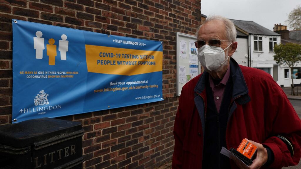 A man walks past a banner featuring a coronavirus testing site set up at St Mary’s church hall in the London borough of Hillingdon, England on May 14th. Photograph: Adrian Dennis / AFP