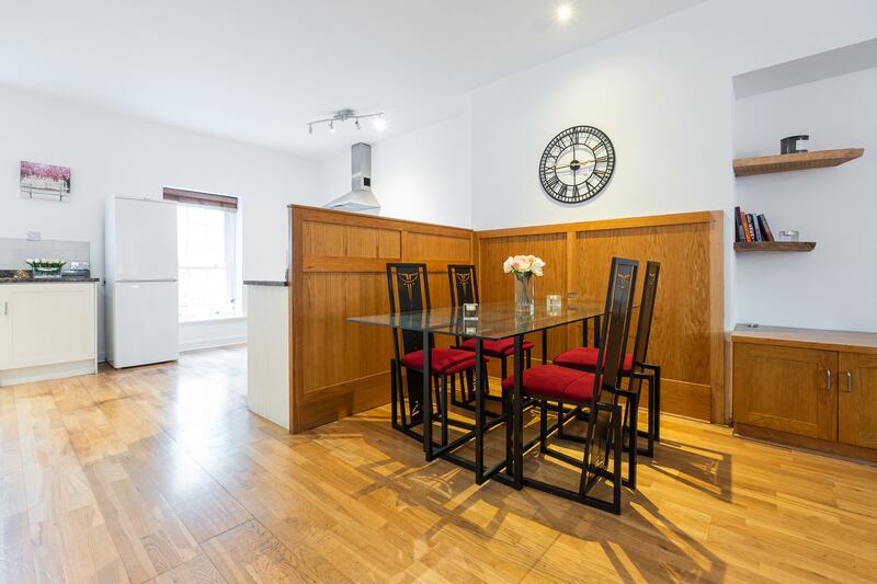 A wood screen marks the end of the living and dining area