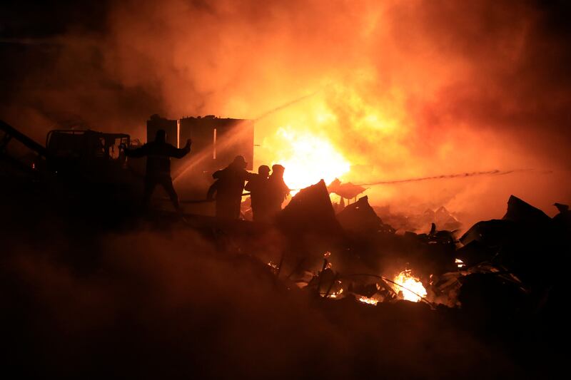 Firefighters battle a warehouse fire following an Israeli air raid in the southern coastal town of Ghaziyeh, Lebanon. Photograph: EPA