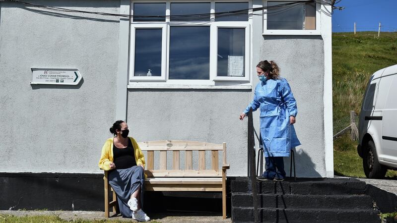 Nurse Margaret Lavelle calls islander Tara McMahon for her vaccination from the waiting area outside the Inishbofin health centre. Photograph: Charles McQuillan/ Getty Images