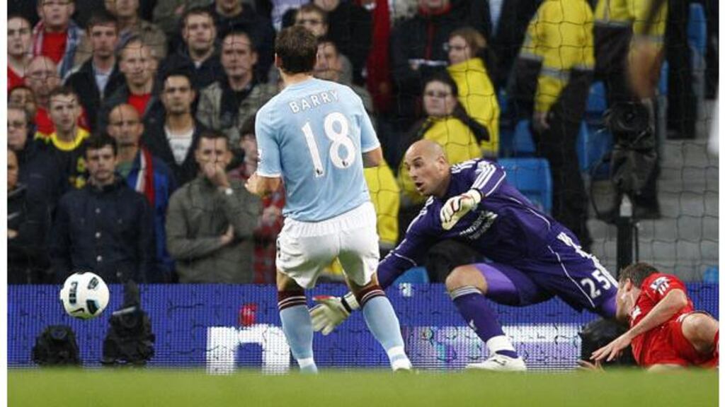 Manchester City's Gareth Barry fires past Pepe Reina to open the scoring against Liverpool. - (Photograph: Darren Staples/Reuters)