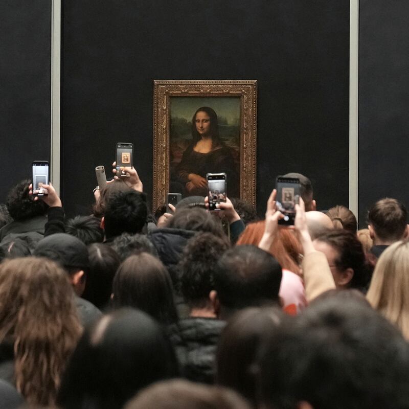 Visitors crowd around the Mona Lisa in the Louvre Museum in Paris. Photograph: Thibault Camus/AP