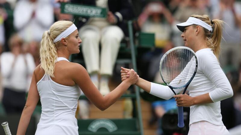 Maria Sharapova of Russia shakes hands at the net with Kristina Mladenovic of France after their first round match on day one of Wimbledon. Photograph: Clive Brunskill/Getty Images