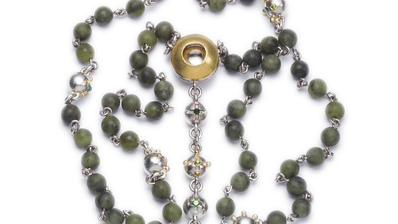 Rosary beads made with platinum and 22ct gold, set with six cabochon cut emeralds, green and white diamonds with Connemara marble beads.