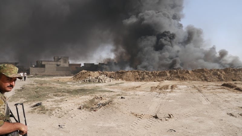A burning oil well lit by retreating Isis fighters, lies within metres of the liberated town of Qayyarah. The fires have been burning since August. Photograph:  Ruaidhri Giblin