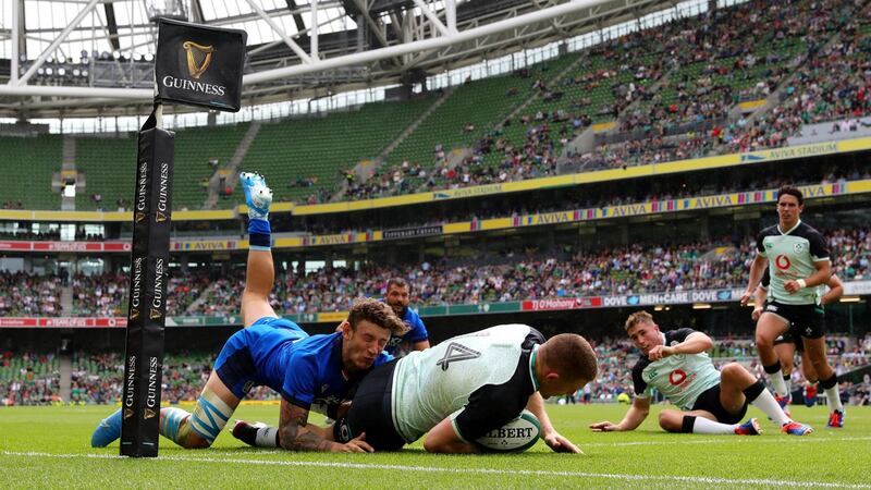 Andrew Conway dives over to score Ireland’s third try as he is tackled by Matteo Minozzi of Italy at the Aviva Stadium on Saturday. Photo by Dan Mullan/Getty Images)