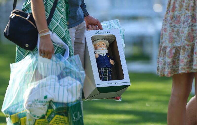 A shopper includes the popular Masters gnome among her purchases from the busy large merchandise outlet at Augusta National Golf Club. Photograph: David Cannon/Getty Images