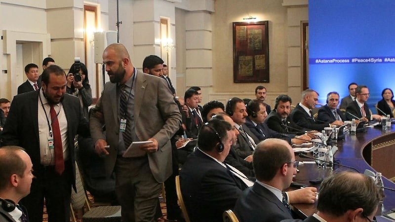 A member of a rebel delegation is led from the venue during the fourth round of Syria peace talks in Astana, Kazakhstan. Photograph: Stanislav Filippov/AFP/Getty Images