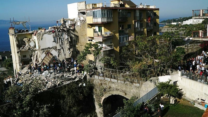 Rescuers work amid the rubble of the building that collapsed. Photograph: AP