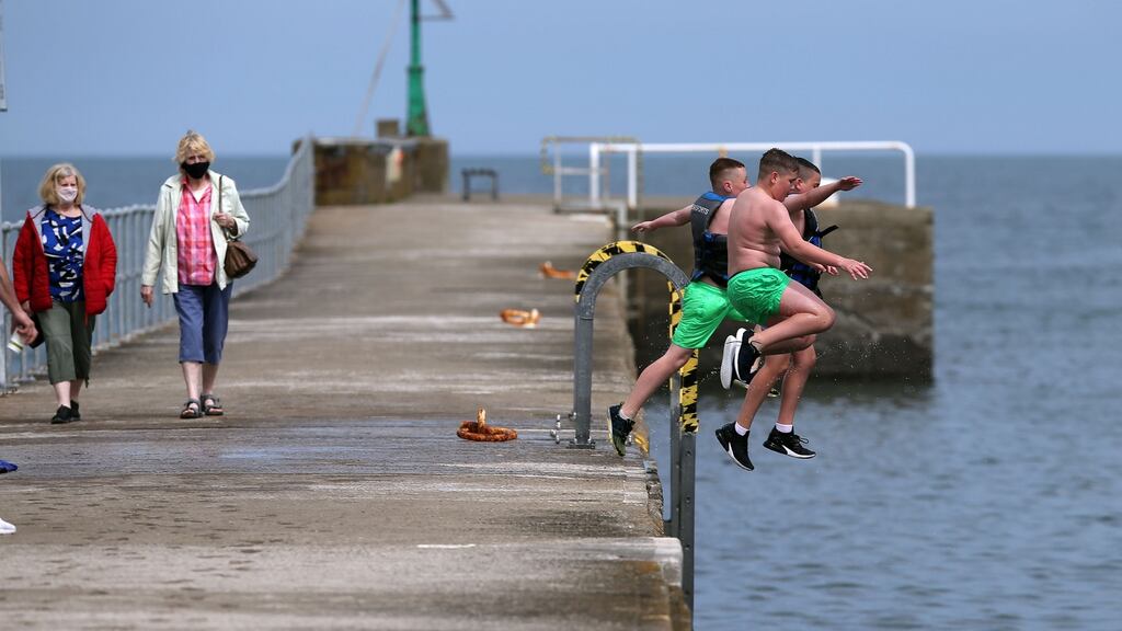 Cousins Scott Moran (11), Craig Donnelly (11) and Sean Jacob (11) jumping into the water off Wicklow Pier on Tuesday. Photograph: Nick Bradshaw