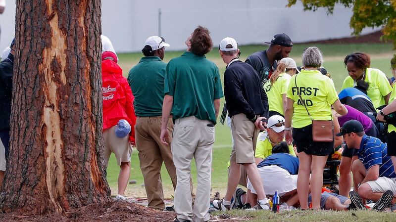 A spectator receives treatment after lightning struck a pine tree at East Lake. Photograph: Erik S Lesser/EPA