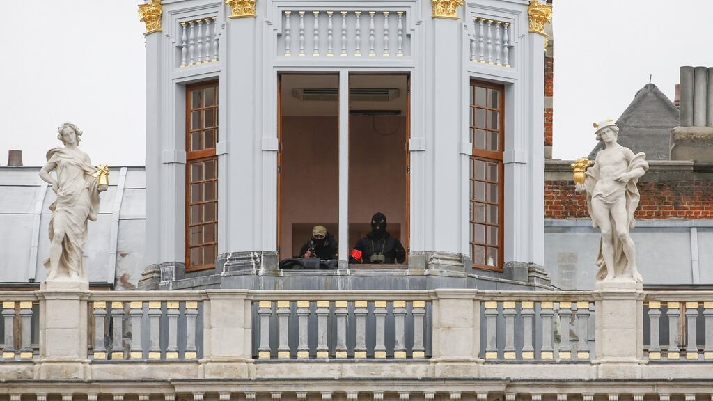 A sniper and an observer of Belgian police special forces are seen on a balcony of a building on Brussels Grand Place after security was tightened in Belgium following the fatal attacks in Paris. Photograph: Yves Herman/Reuters