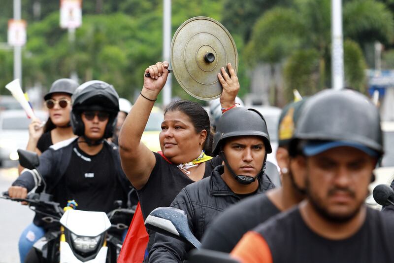 A woman bangs a cooking pot lid during a protest against Venezuelan president Nicolás Maduro's government in Valencia, Carabobo state. Photograph: Juan Carlos Hernandez/AFP via Getty Images