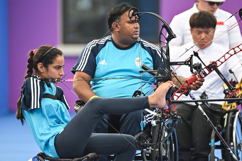 India's Devi Sheetal (left) and Kumar Rakesh compete in the mixed team compound, open gold medal archery match during the 2022 Asian Para Games in Hangzhou, in China's eastern Zhejiang province. Photograph: Getty Images
