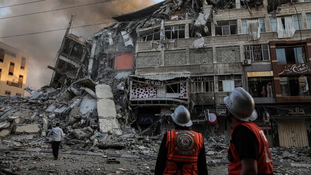 Safety officials inspect damaged buildings in Gaza City on Wednesday following an Israeli air strike. Photograph: Hosam Salem/New York Times