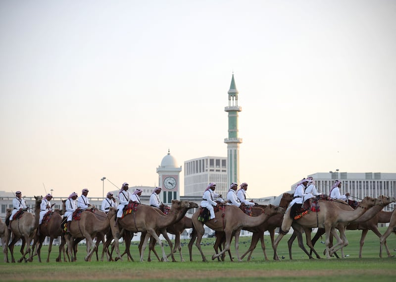 Camel-mounted royal guards patrol around the Amiri Diwan in Doha. Photograph: Adrian Dennis/AFP via Getty