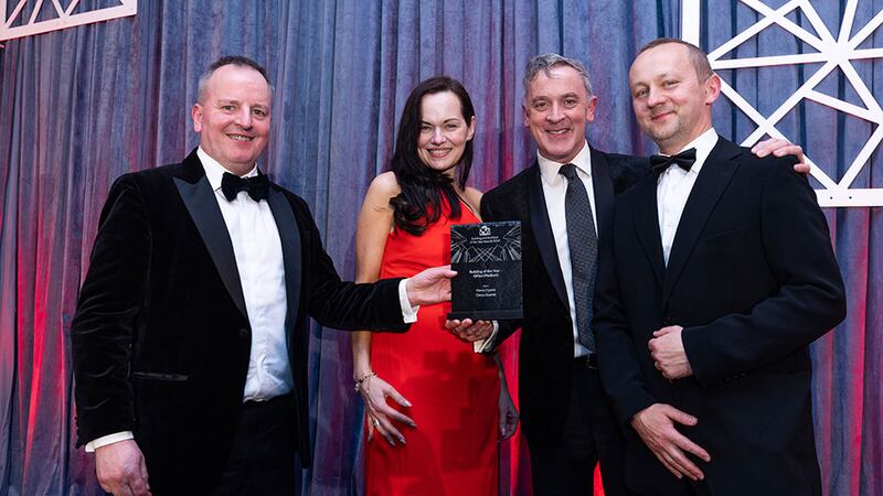 Barry Hennessy, business development & marketing director, Walls Construction presents the building of the year – office (medium) to the Henry J Lyons team