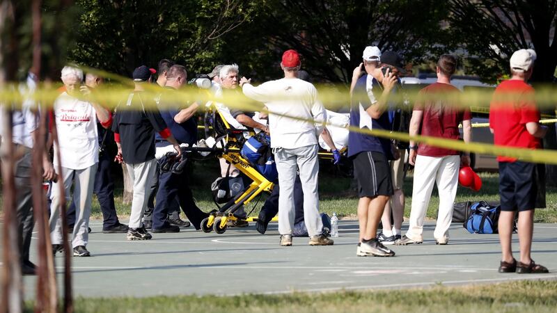 A person is loaded on to a stretcher as members of the Republican congressional baseball team look on following a shooting in Alexandria, Virginia on Wednesday. Photograph: Shawn Thew/EPA