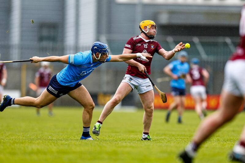 Westmeath’s Davy Glennon makes a hand pass under pressure from Eoghan O'Donnell of Dublin. Photograph: Ashley Cahill/Inpho