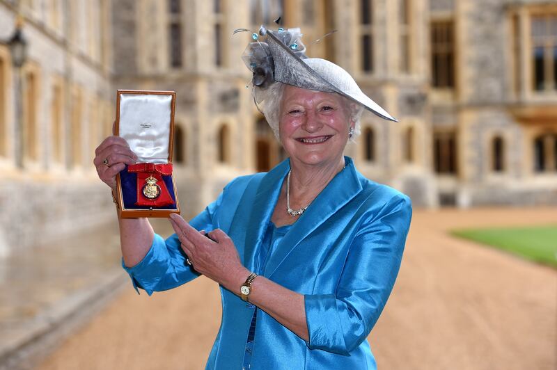 Mary Peters holds her insignia of member of the Order of the Companions of Honour services to Sport and to the community in Northern Ireland at an investiture ceremony at Windsor Castle. Photograph: Andrew Matthews - WPA Pool/Getty