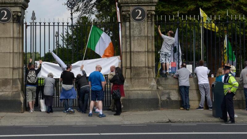 Protestors outside Glasnevin Cemetery during a ceremony attended by President Michael D Higgins and the Duke of Kent where they unveiled the Commonwealth Graves Commission Cross of Sacrifice. Photograph: Brenda Fitzsimons