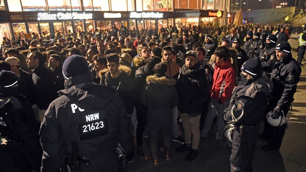 Police officers surround a group of men in front of the main station in Cologne, western Germany, last weekend. Photograph: Henning Kaiser/dpa via AP