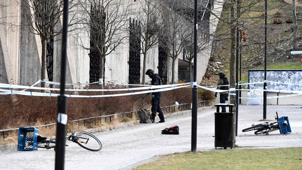 Swedish police investigate the area outside Vårby Gård station in Stockholm, where two people were injured, one fatally, in an explosion. Photograph: TT News Agency/Henrik Montgomery/AFP/Getty Images