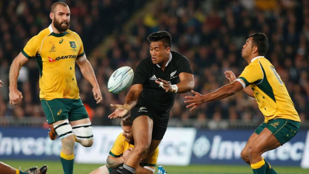 Julian Savea (C) of New Zealand’s All Blacks gets the ball away while being tackled by Pat McCabe (bottom) of Australia during their second Bledisloe Cup rugby championship match at Eden Park in Auckland. Photoghraph: REUTERS/Nigel Marple