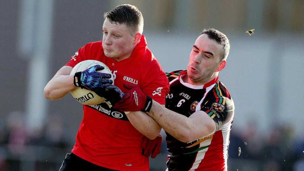 UCC’s Conor Cox is challenged by Carlow IT’s Thomas Featherston during the Sigerson Cup semi-final at The Mardyke in Cork. Photograph: Donall Farmer/Inpho