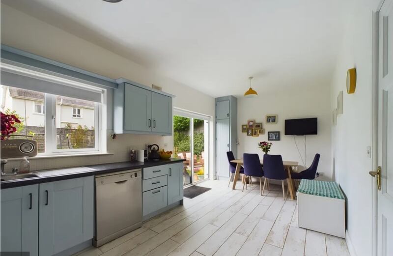 44 An tSean Dún: The kitchen has been nicely fitted out with distressed white wooden floorboards and contemporary light-blue units.