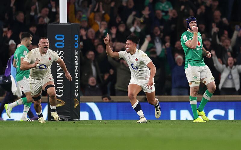 Marcus Smith of England celebrates scoring the winning drop goal against Ireland with teammates at Twickenham. Photograph: Julian Finney/Getty