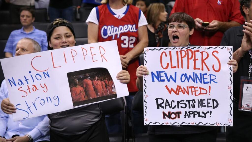 Los Angeles Clippers fans hold up signs referencing the Donald Sterling situation before the game with the Golden State Warriors. Photograph: Stephen Dunn/Getty Images