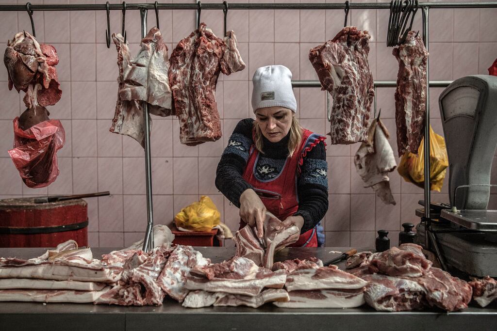 A butcher at work in her shop in Kherson, Ukraine, after supplies returned to the city following its liberation from the Russians. Photograph: Finbarr O’Reilly/The New York Times