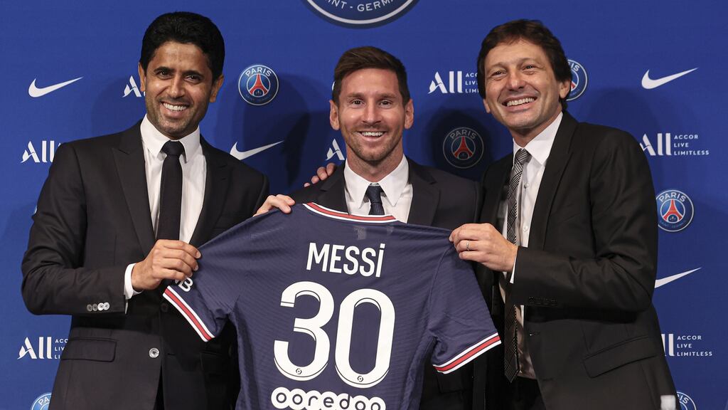 Lionel Messi with his new PSG jersey and club president Nasser Al Khelaifi and Leonardo at the Parc des Princes. Photograph: Sebastien Muylaert/Getty Images