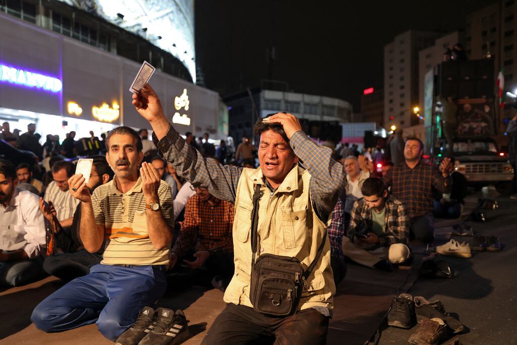 Iranians pray in Valiasr Square in central Tehran on Sunday following news of the helicopter crash in bad weather in East Azerbaijan Province. Photograph: Atta Kenare/AFP via Getty Images