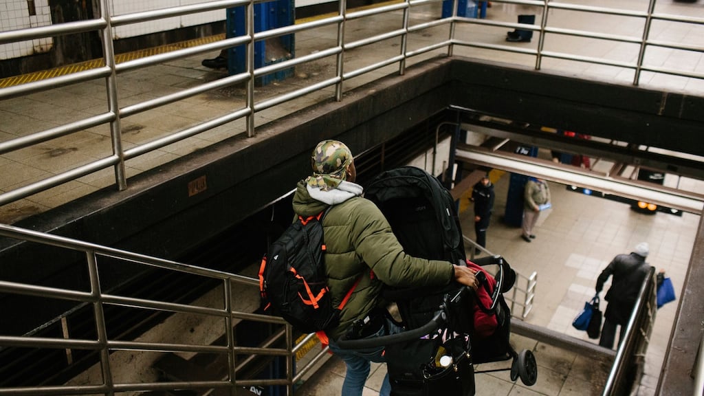 A stroller is carried down the stairs at the 53rd Street & Seventh Avenue station in New York on Tuesday. Photograph: Gabriela Bhaskar/The New York Times