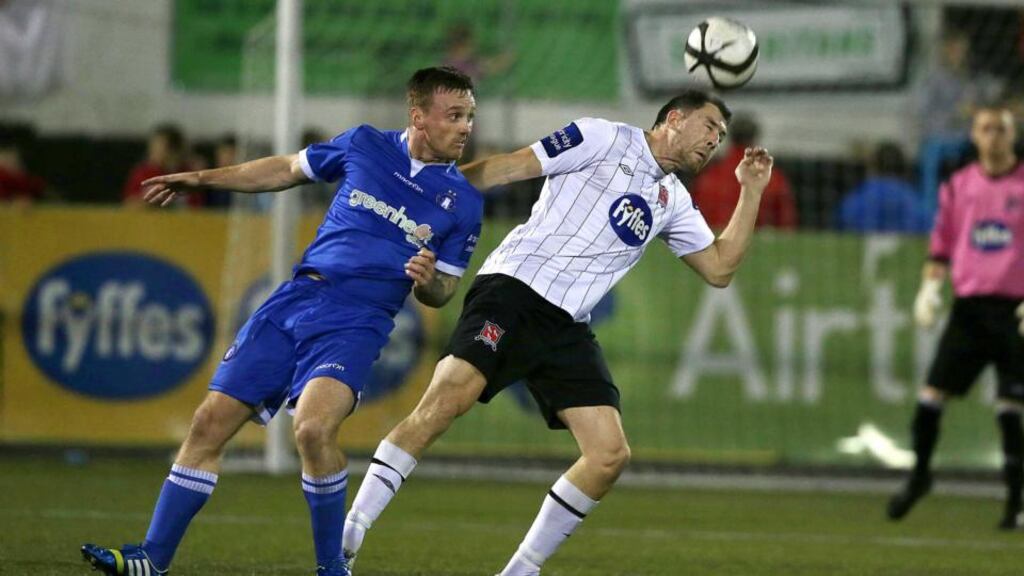 Dundalk’s Brian Gartland with Craig Curran of Limerick at Oriel Park last night. Photograph: Morgan Treacy/Inpho