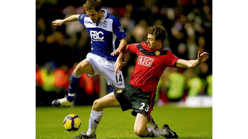 Birmingham City's Roger Johnson skips over the challenge of Manchester United's Jonny Evans during their Premier League clash at St Andrew's on Saturday evening.
