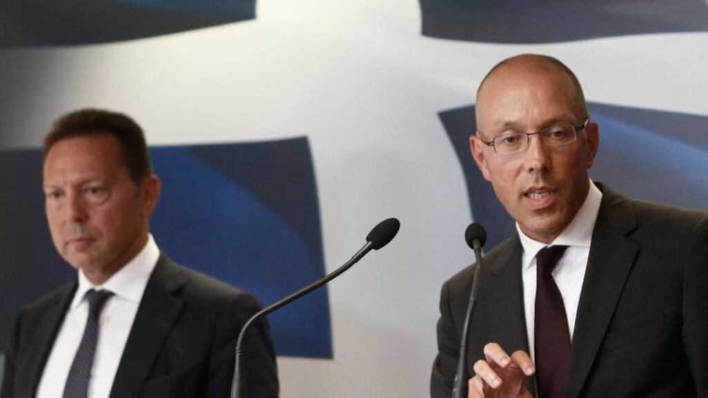 European Central Bank executive board member Joerg Asmussen (right) addresses reporters with Greece’s finance minister Yannis Stournaras in Athens yesterday. Photograph: Reuters