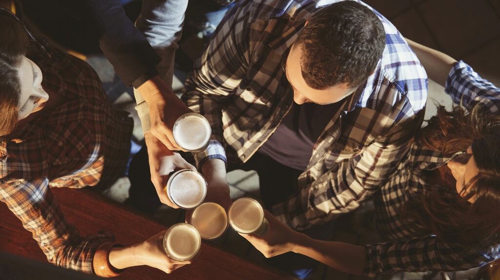 Cheers toasting beer. Group of friends enjoying in cold drink. Drinking beer in the old pub. The grain and texture added. Very shallow DOF .