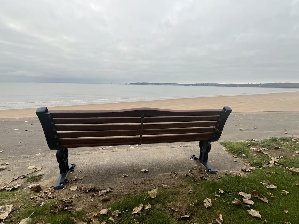 A memorial bench at the promenade overlooking Swansea Bay