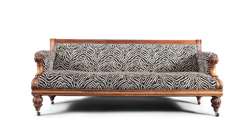 Lot 382: a reupholstered William IV mahogany-framed three-seater settee, complete with traditional lotus-carved turned legs and casters (€1,000-€1,500).